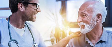 Friendly clinician engaging with a male patient